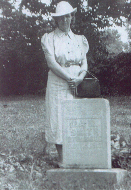 Ida's sister Mollie stands next to Ida's grave.
