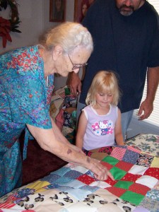 My grandmother Malinda (Smith) Beaty shows my daughter Molly a quilt she made.